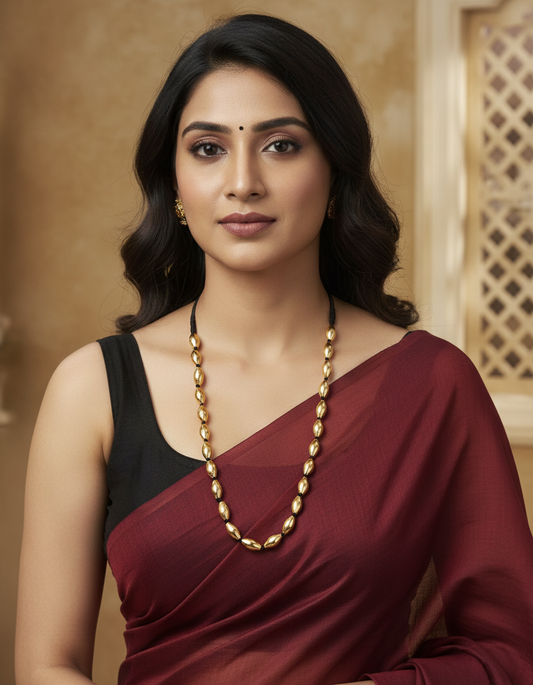 Hemali Suvarna Thread Ganthan Necklace - gold oval bead black thread traditional Maharashtrian necklace is worned my a women in maroon saree