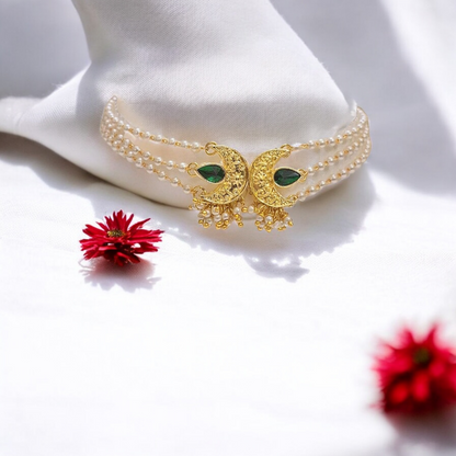 Handmade gold chandbali choker necklace set with green stones and pearl detailing for women in India
