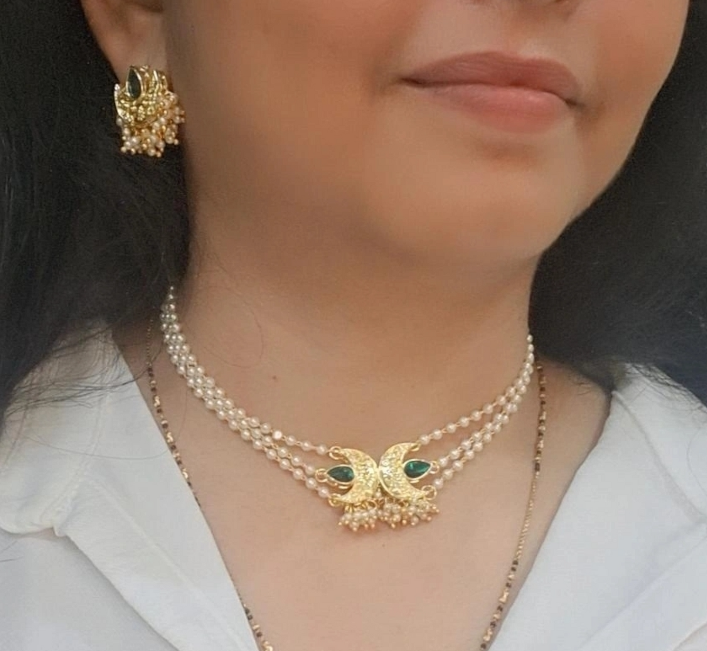 Handmade gold chandbali choker necklace set with green stones and pearl detailing for women in India