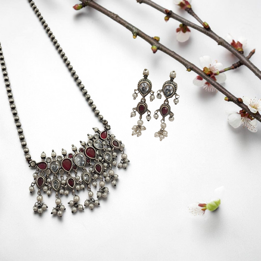 Oxidised red and white stone statement necklace set with pearl drops and matching earrings in antique silver finish ethnic jewellery