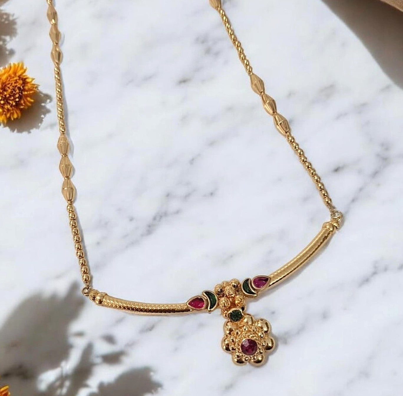 Gold finish Maharashtrian pendant necklace set with ruby and green stones for women