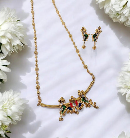 Tarika Rangoli colourful gold plated necklace set with multicolour enamel detailing and matching earrings by Indiaura Mode