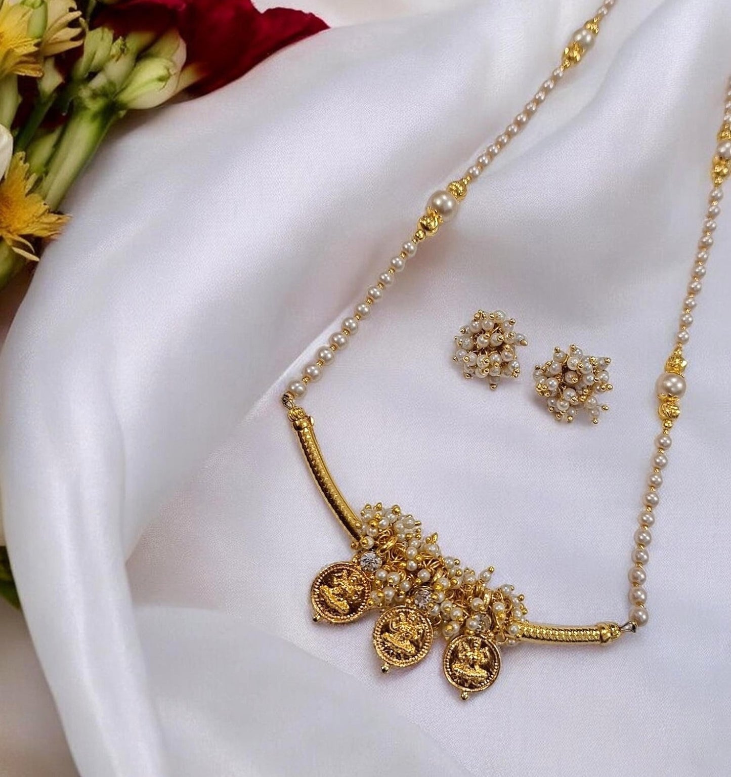 Tarika Shree gold plated Maharashtrian necklace set with Lakshmi coin charms, pearl detailing and matching earrings by Indiaura Mode