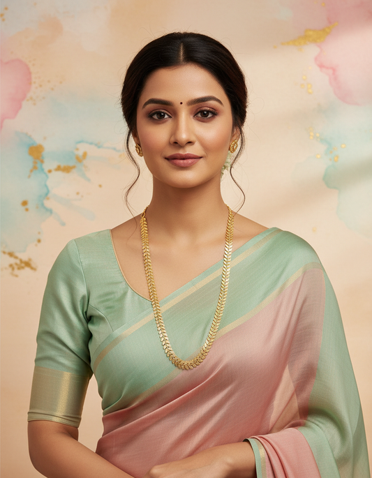 A woman in pastel saree wearing Uparna gold plated leaf chain long necklace