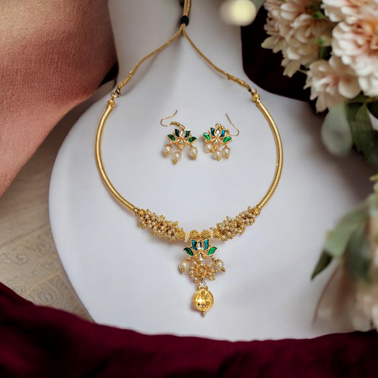 Lakshmi coin pearl choker necklace set with green meenakari lotus and matching earrings, handmade temple jewelry from India.